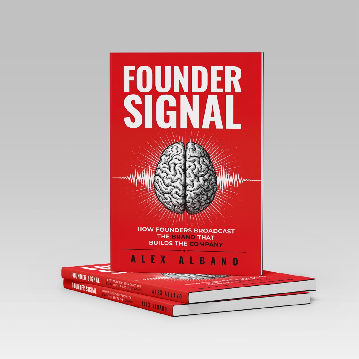 Founder Signal hardcover standing on a stack of two copies